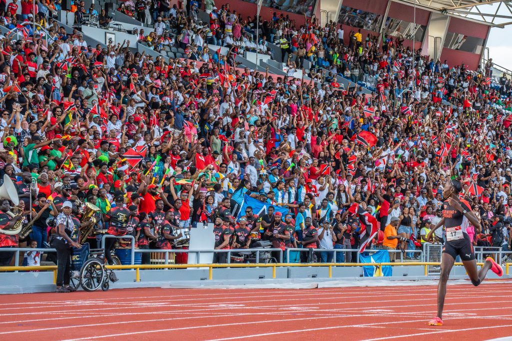 O’Shea Cummings of Trinidad and Tobago crossing the finish line in front of a roaring home crowd at CARIFTA 2025.